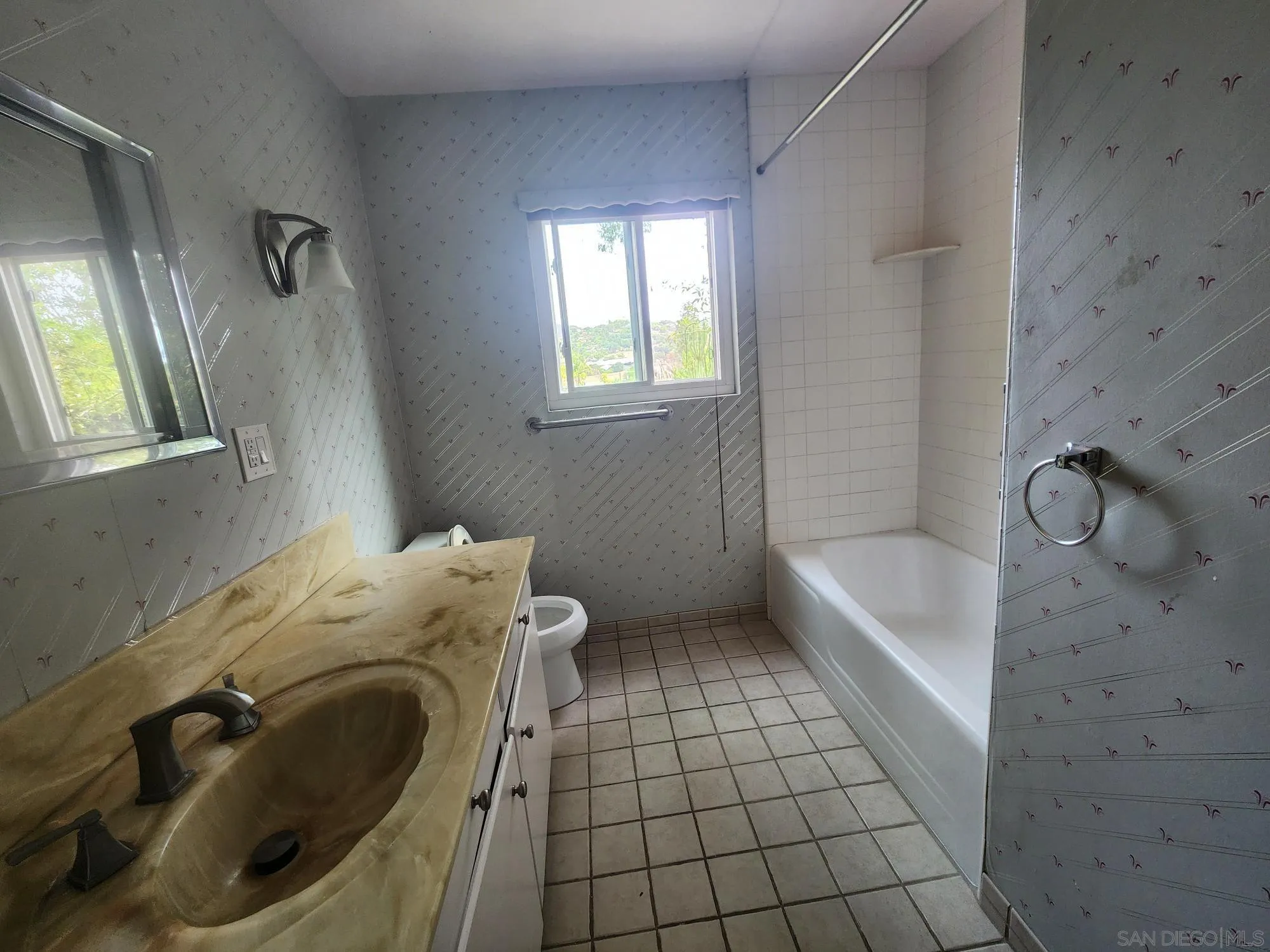 1972 Buena Creek Road Vista, CA 92084 - Photo 14 of 22 a bathroom with a sink a toilet and bathtub