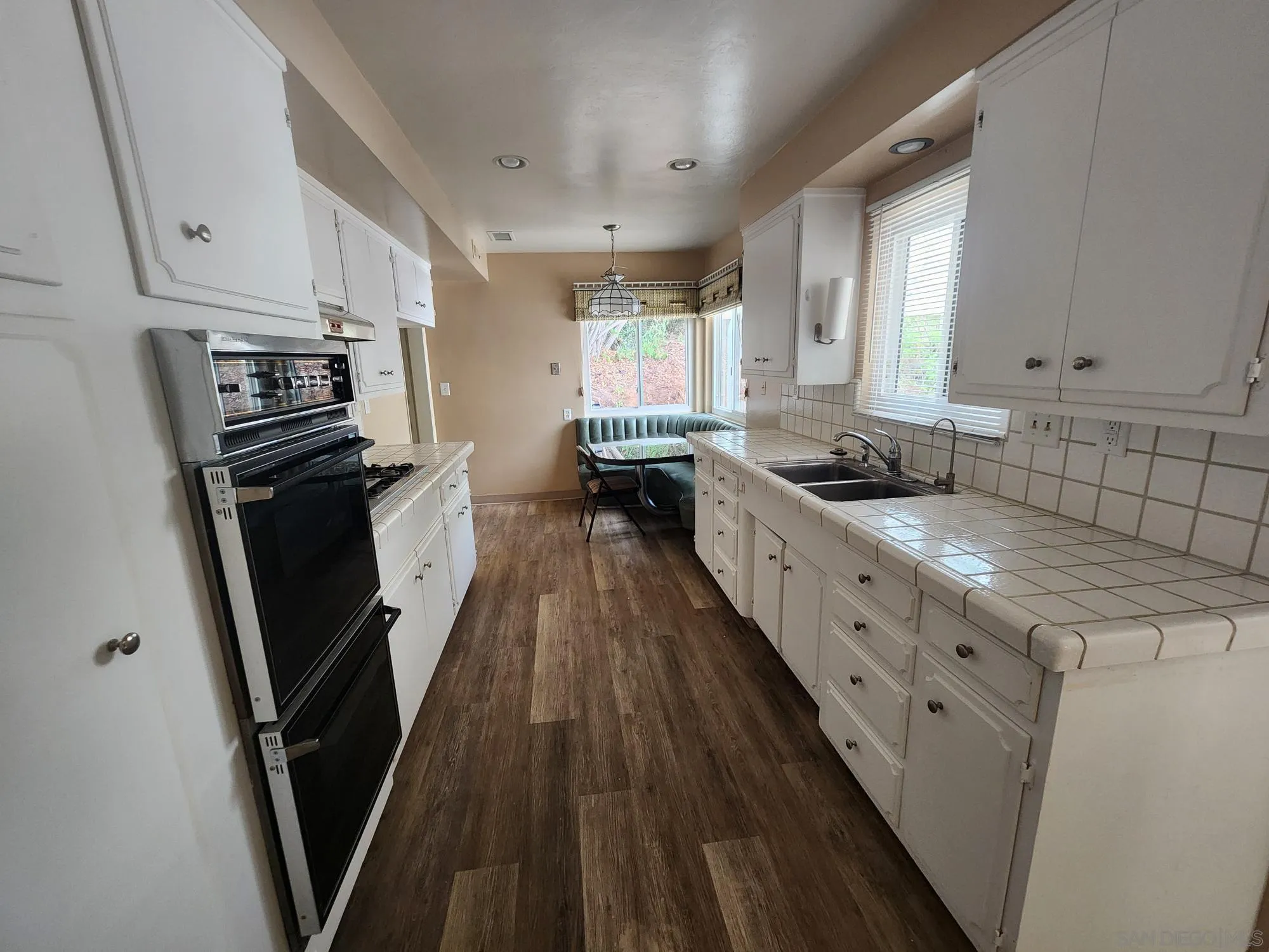 1972 Buena Creek Road Vista, CA 92084 - Photo 7 of 22 a kitchen with granite countertop a sink stove and refrigerator