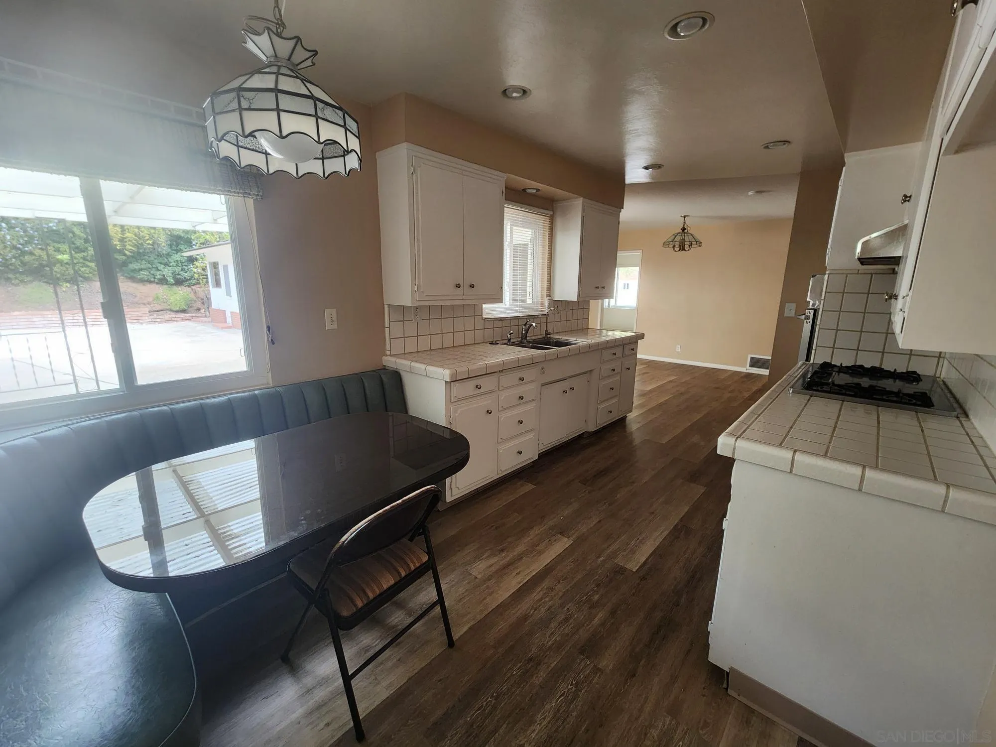 1972 Buena Creek Road Vista, CA 92084 - Photo 8 of 22 a living room with furniture and a chandelier