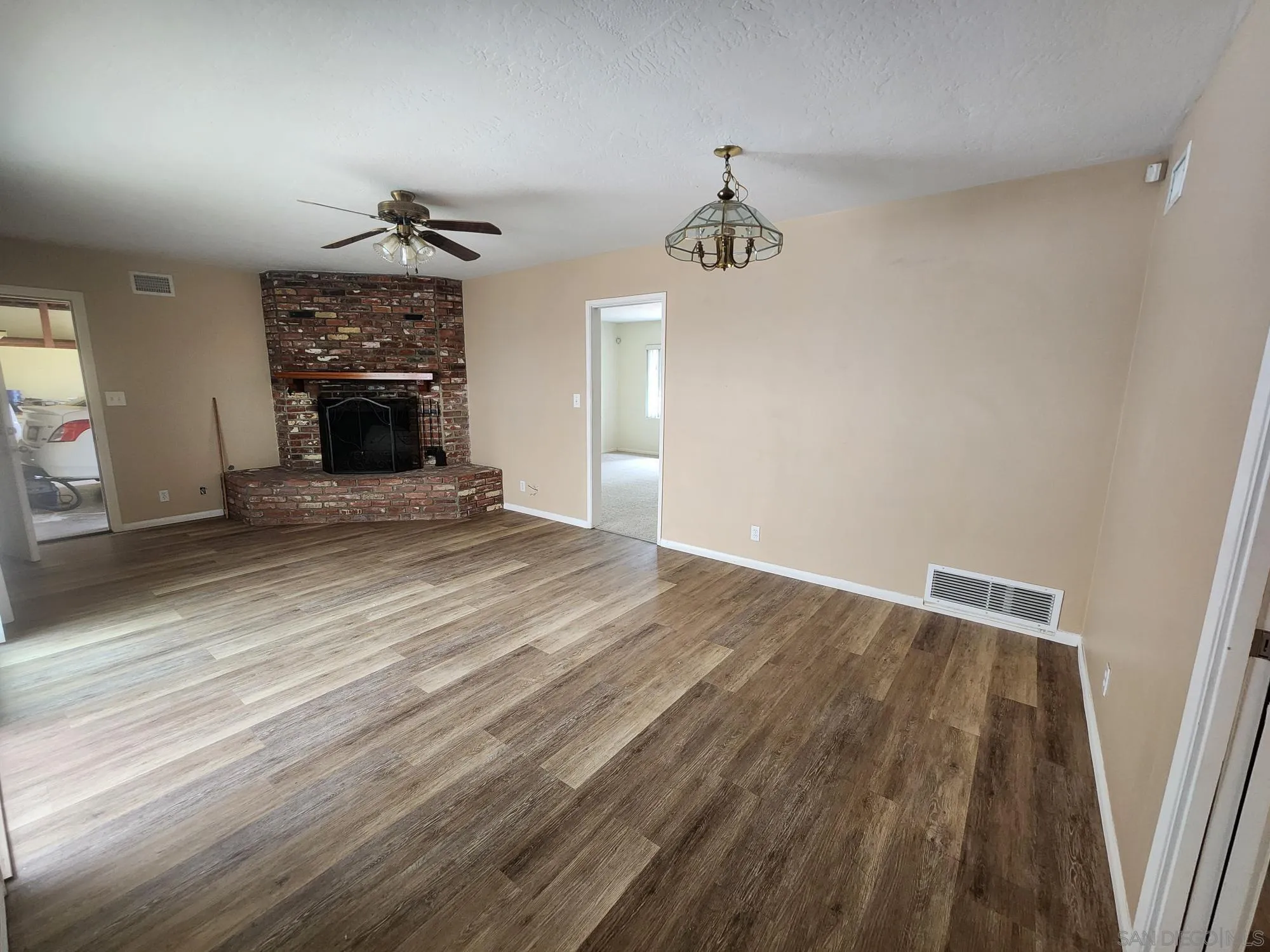 1972 Buena Creek Road Vista, CA 92084 - Photo 10 of 22 wooden floor in an empty room with a fireplace