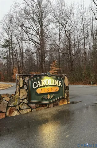 a view of a street with a bench and trees
