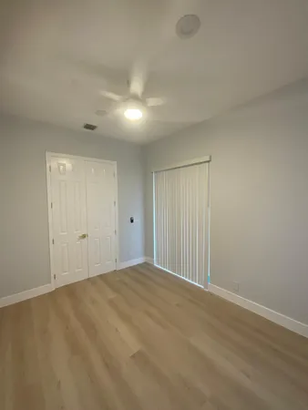 a bathroom with a double vanity sink toilet and mirror