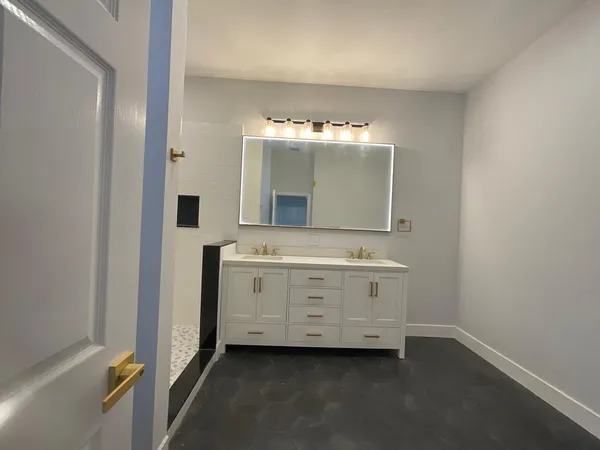 a view of a room with wooden floor and white walls