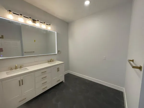 an empty room with cabinet and windows