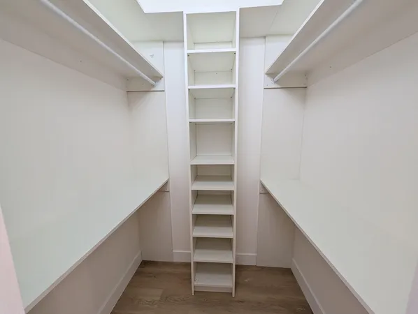 an empty room with a empty space and windows