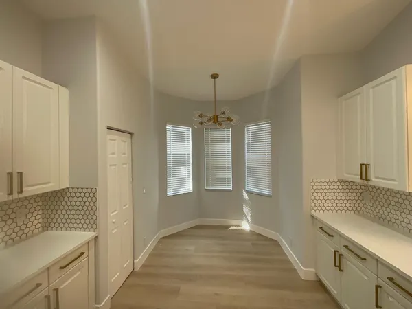 a spacious bathroom with a sink and a mirror