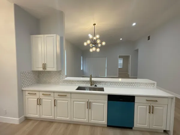 a kitchen with stainless steel appliances a sink stove and refrigerator