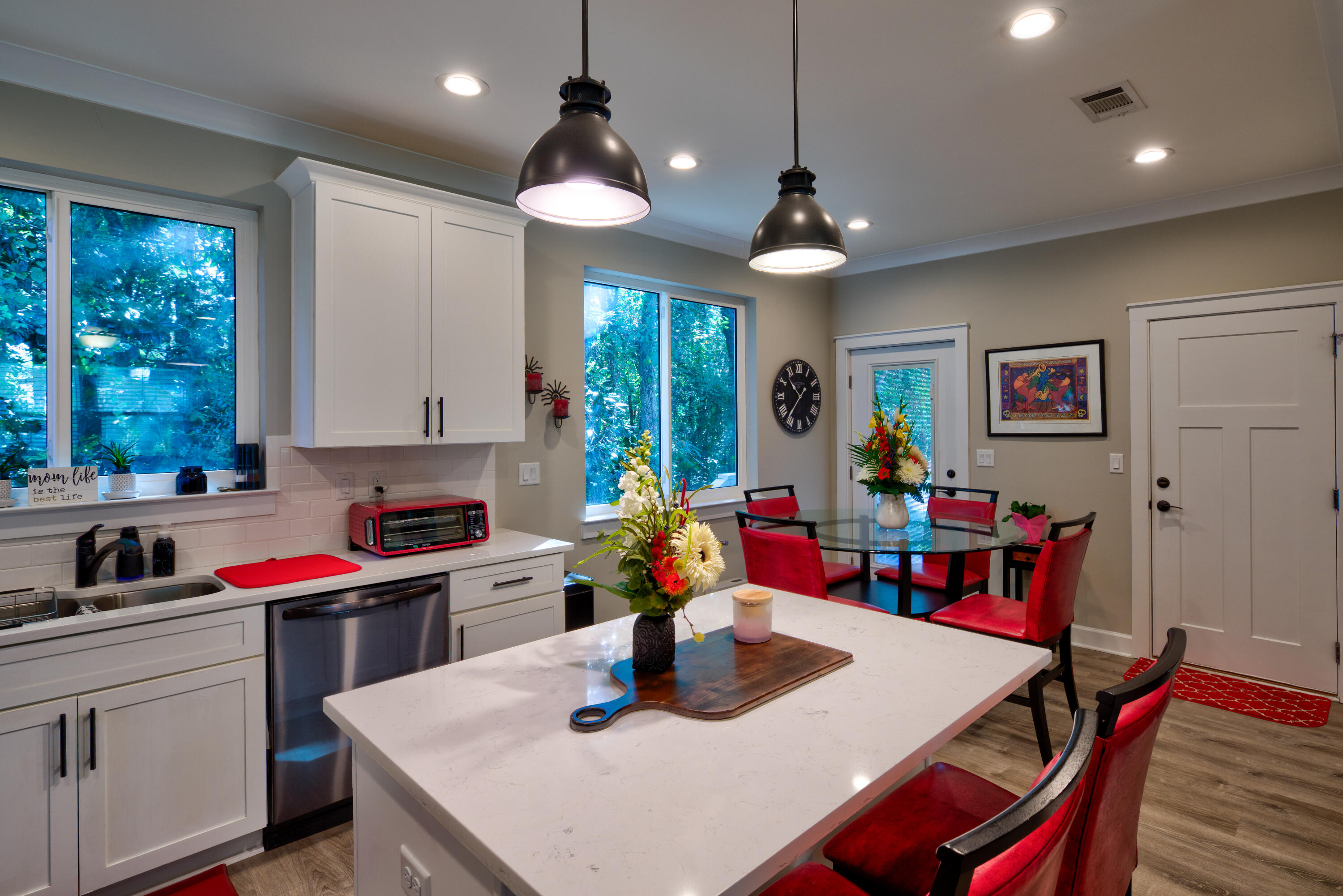527 Maple Avenue Niceville, FL 32578 - Photo 11 of 42 a kitchen with a dining table chairs refrigerator and sink