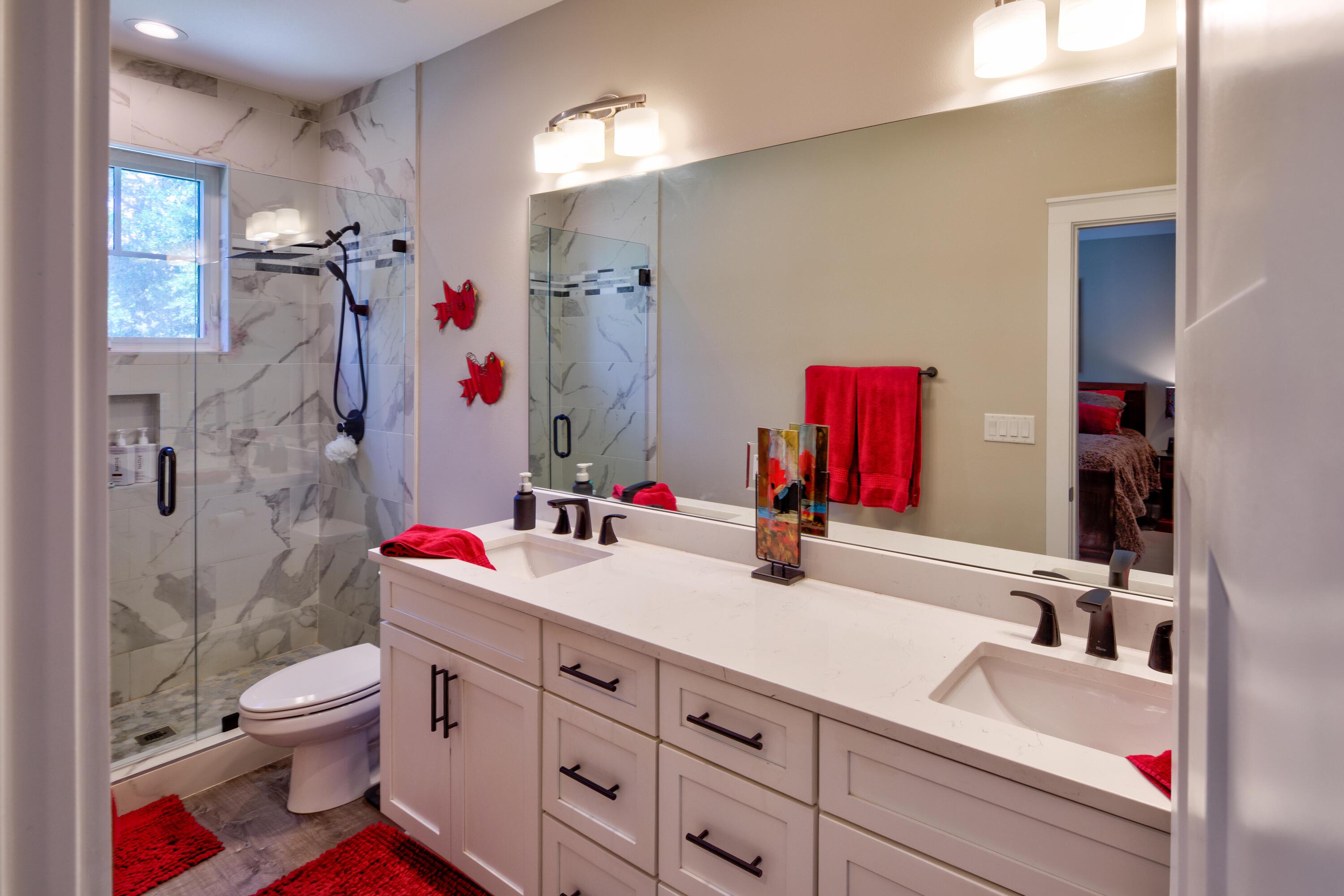 527 Maple Avenue Niceville, FL 32578 - Photo 23 of 42 a bathroom with a sink vanity mirror and toilet