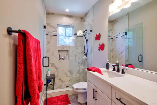 a bed room with a bed window and a flat screen tv