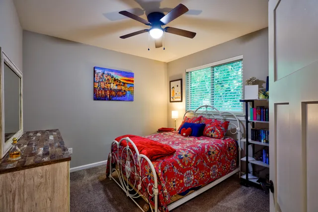 a bedroom with a bed and a large window