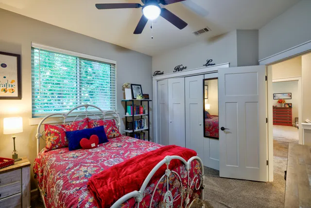 a bedroom with a bed and a dresser in it