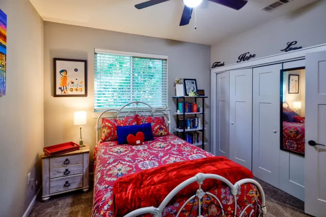 a bedroom with a bed and a chandelier