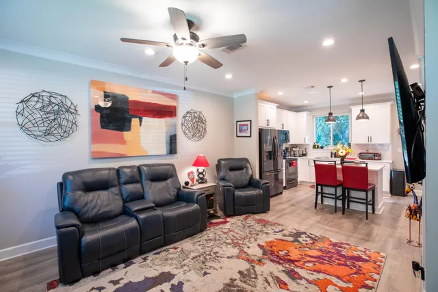 a living room with furniture a rug and a chandelier