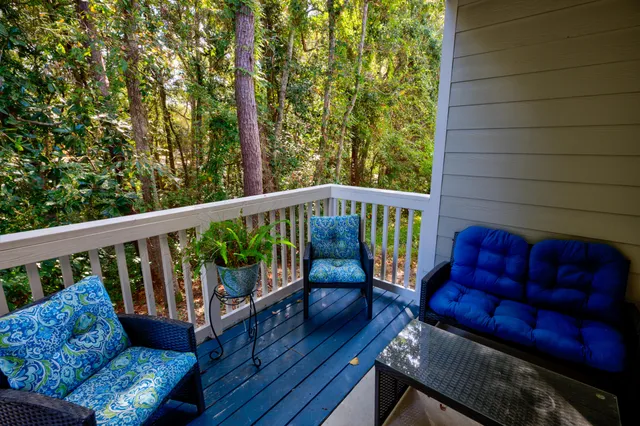 a view of a balcony with wooden floor