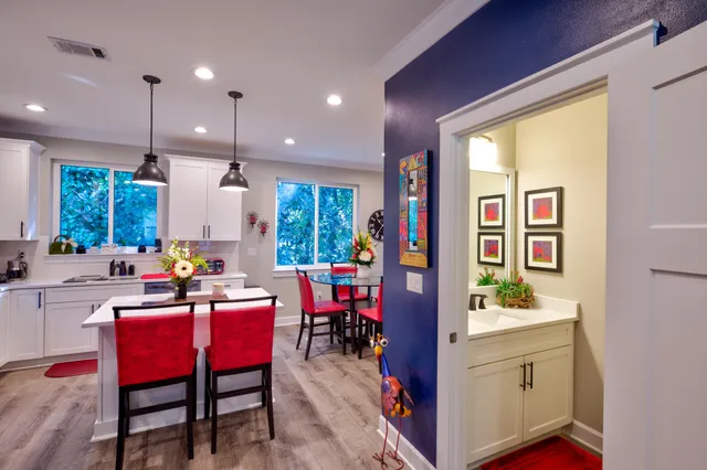 a view of kitchen with dining table chairs sink and white appliances