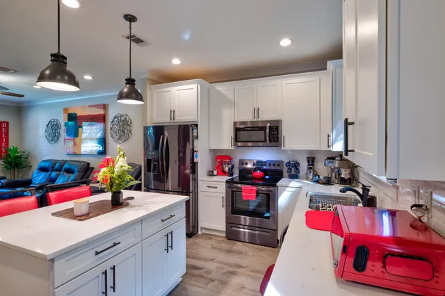 a kitchen that has a lot of cabinets and refrigerator