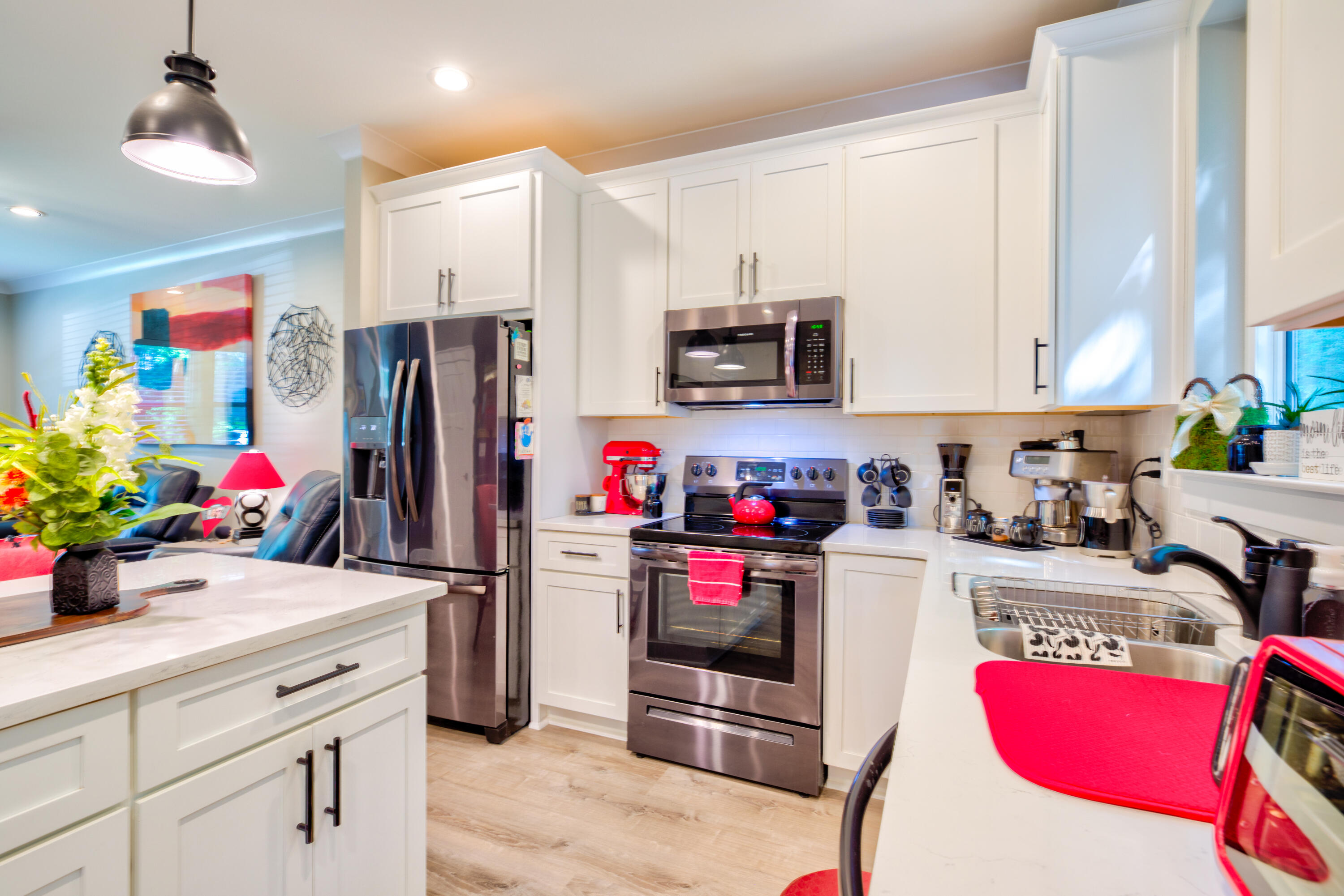 527 Maple Avenue Niceville, FL 32578 - Photo 10 of 42 a kitchen with refrigerator a microwave a stove and cabinets