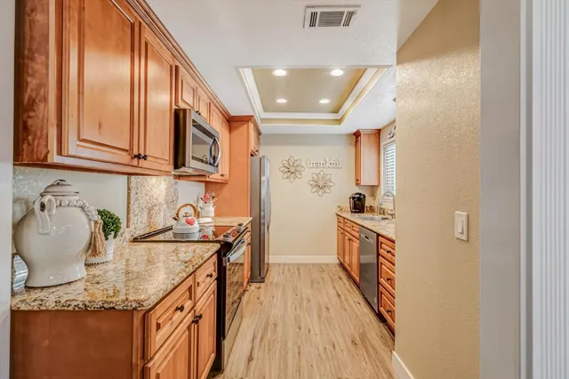 a kitchen with a sink stove and cabinets