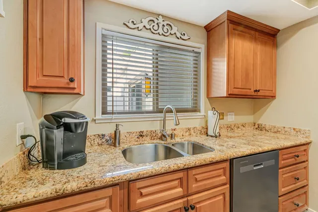 a kitchen with granite countertop a sink and a window