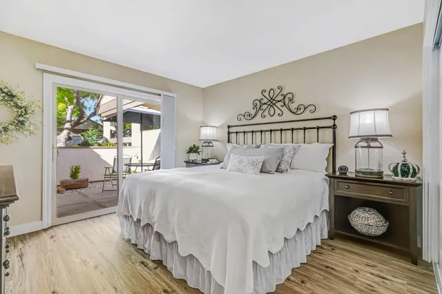 a bed sitting in a bedroom next to a window