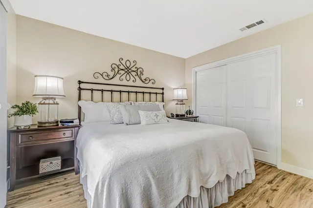 a bedroom with a bed and a lamp on table