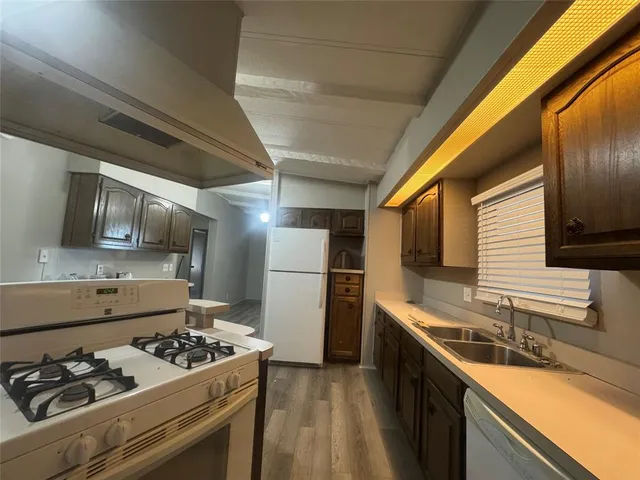 a kitchen with a sink stove and refrigerator