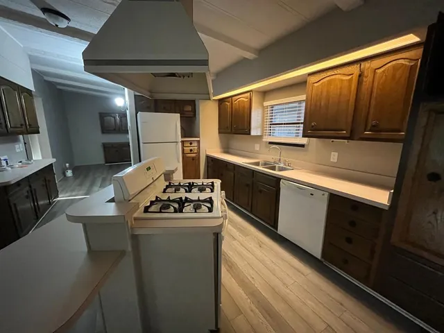 a kitchen with stainless steel appliances a sink stove and refrigerator
