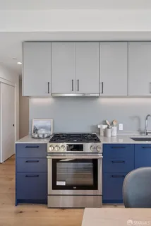 a kitchen with granite countertop a stove and a wooden cabinets