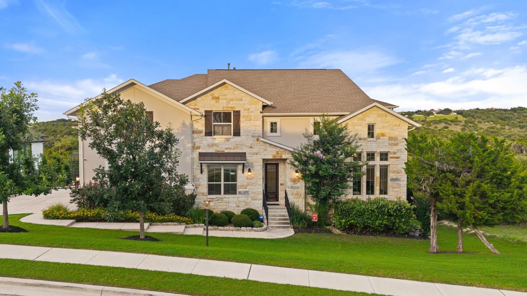 215 Lodestone Lane Austin, TX 78738 - Photo 11 of 40 A classic stone and stucco home welcomes with landscaping and inviting curb appeal.