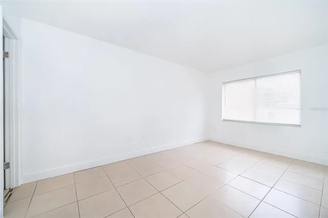 a bathroom with a granite countertop bathtub sink mirror vanity and toilet