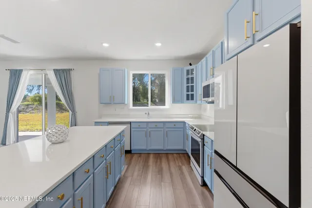 a kitchen with a sink stove and refrigerator