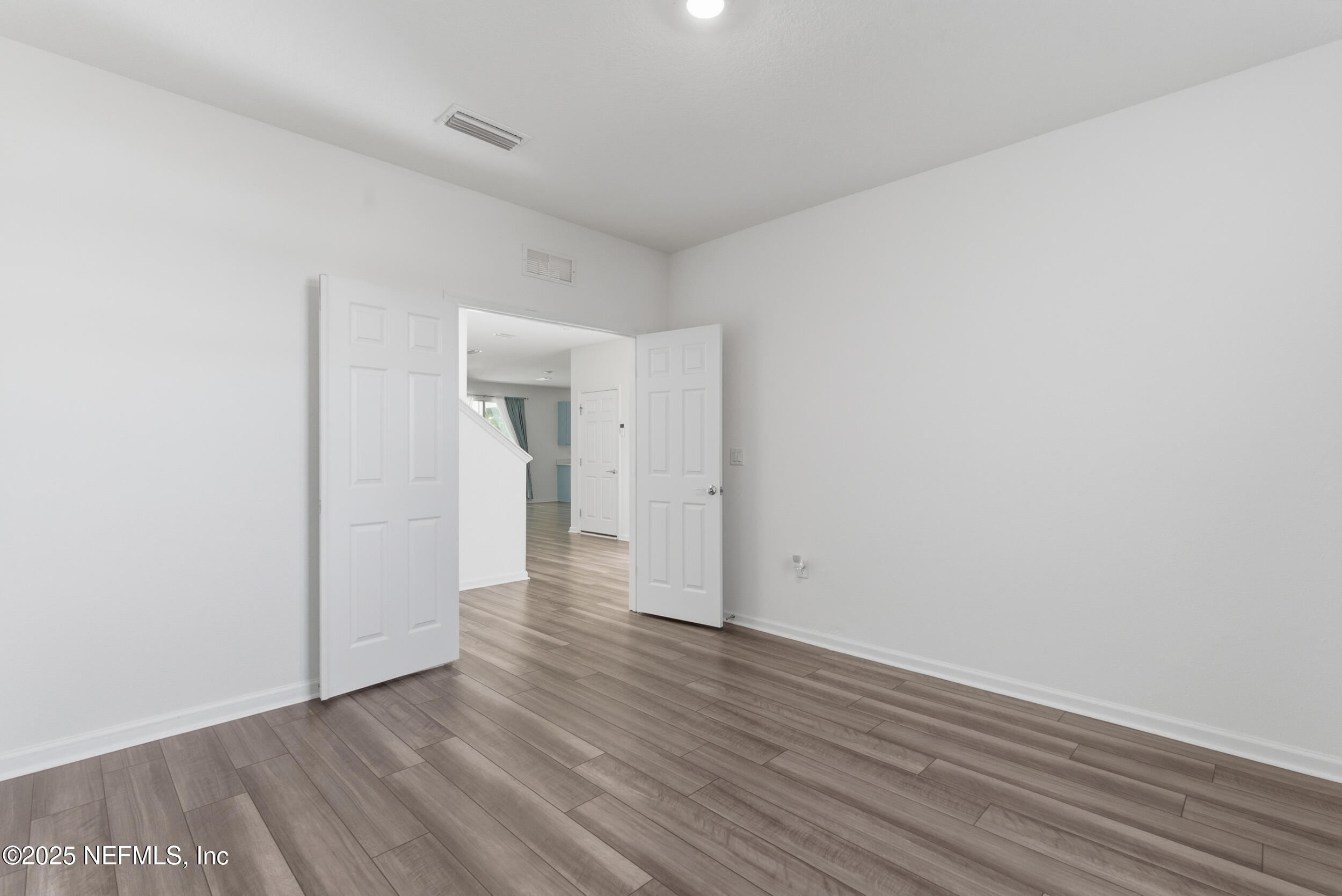 11624 Double Eagle Court Jacksonville, FL 32221 - Photo 6 of 53 a view of an empty room with wooden floor and a window