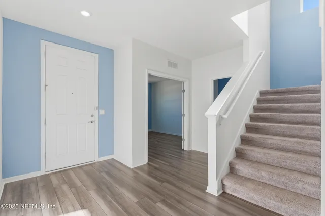 a view of an entryway with wooden floor