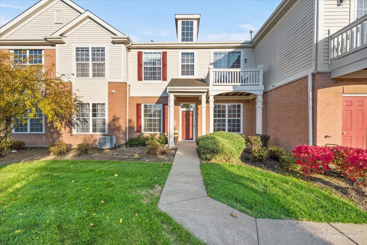 2237 Concord Drive, Unit 2237 McHenry, IL 60050 - Photo 1 of 19 front view of a brick house with a yard