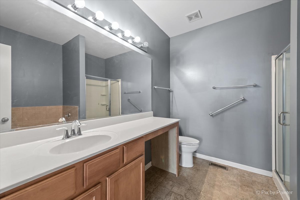 2237 Concord Drive, Unit 2237 McHenry, IL 60050 - Photo 12 of 19 a bathroom with a sink toilet and a mirror