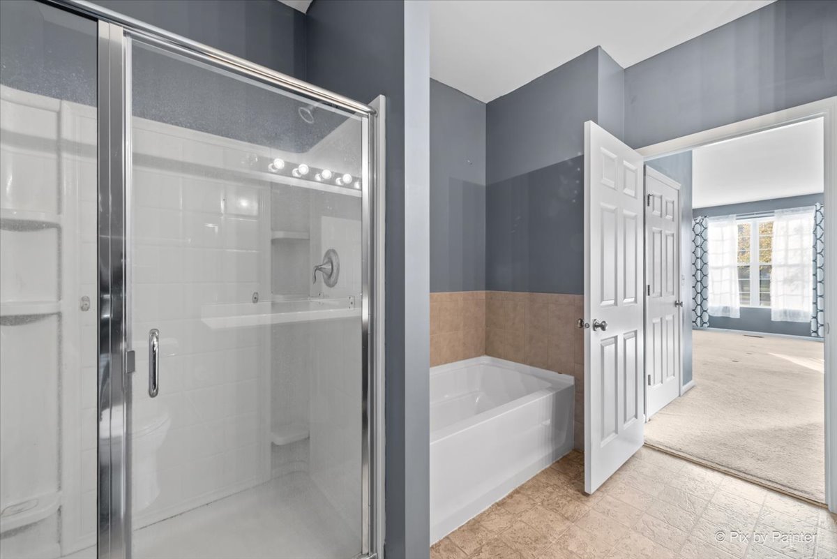 2237 Concord Drive, Unit 2237 McHenry, IL 60050 - Photo 13 of 19 a bathroom with a bathtub and a shower