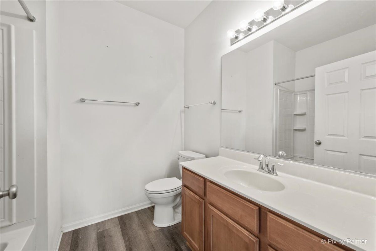 2237 Concord Drive, Unit 2237 McHenry, IL 60050 - Photo 17 of 19 a bathroom with a sink toilet and vanity