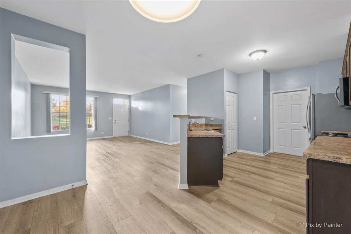 2237 Concord Drive, Unit 2237 McHenry, IL 60050 - Photo 5 of 19 a kitchen with granite countertop a refrigerator and a sink