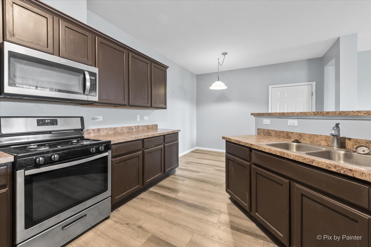 2237 Concord Drive, Unit 2237 McHenry, IL 60050 - Photo 8 of 19 a kitchen with stainless steel appliances granite countertop a stove and a microwave