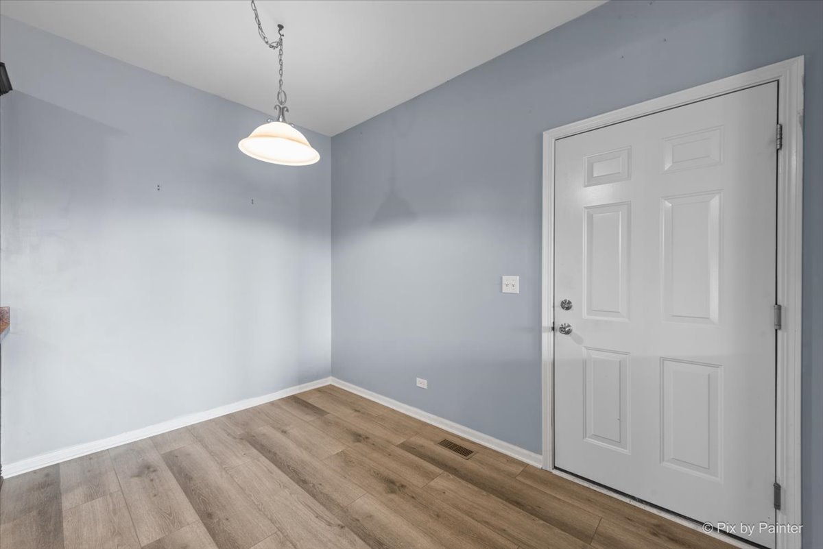2237 Concord Drive, Unit 2237 McHenry, IL 60050 - Photo 10 of 19 a view of empty room with wooden floor and ceiling fan