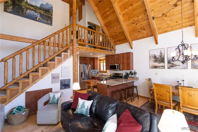 a kitchen with stainless steel appliances granite countertop a refrigerator a stove top oven a sink and dishwasher