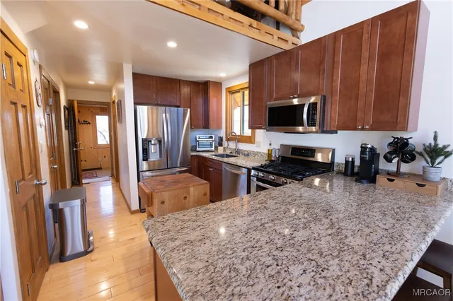 a kitchen with stainless steel appliances a refrigerator and a stove top oven