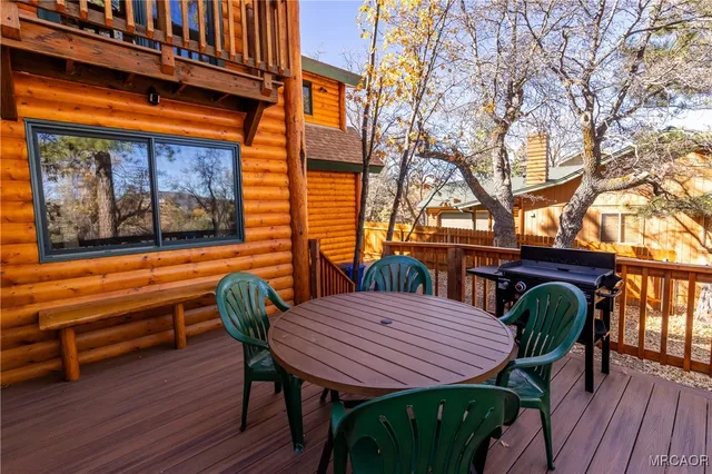 a bedroom with a bed and a flat tv screen on the dresser