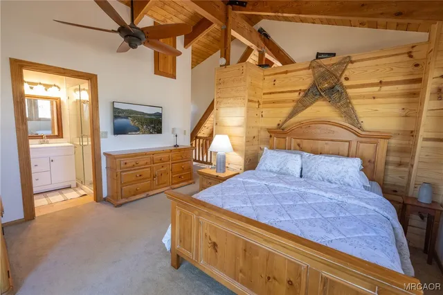 a bedroom with a bed and large windows