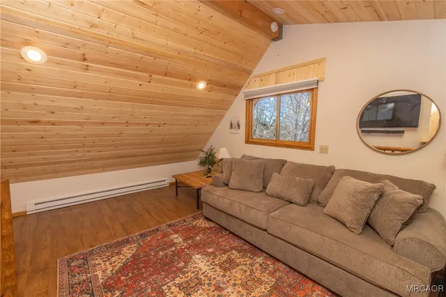 a view of a room with wooden floor and windows