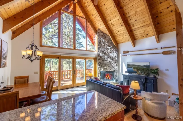 a living room with furniture and a floor to ceiling window