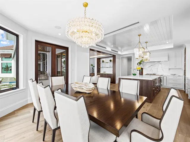 a view of a hallway with wooden floor and a bathroom