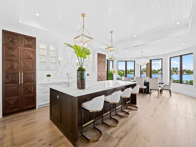 a view of an empty room with wooden floor and windows