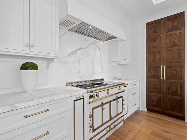 a view of a hallway with wooden floor and a living room